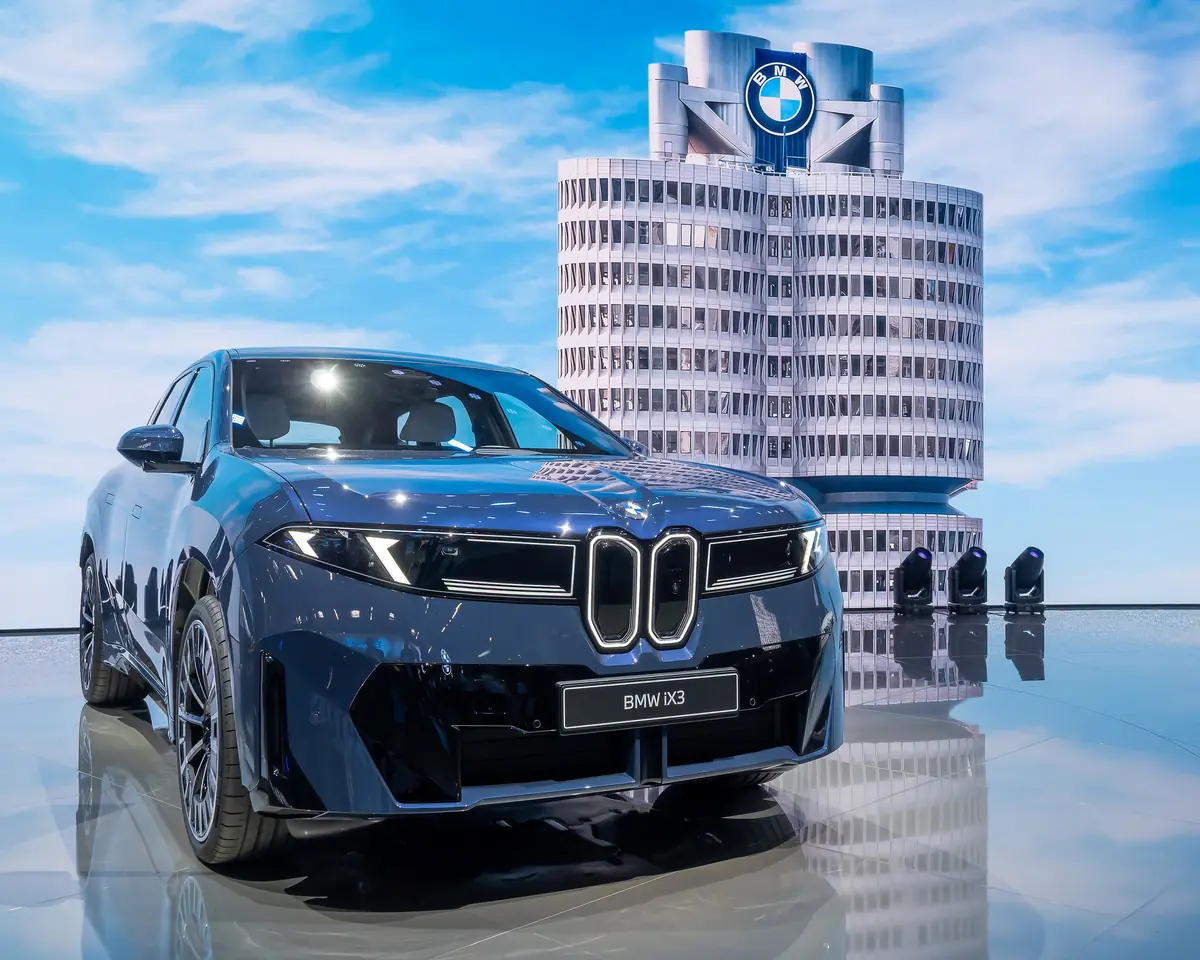 BMW i4 discontinued: the blue Neue Klasse iX3, sibling of the replacement i3, outside BMW headquarters in Munich