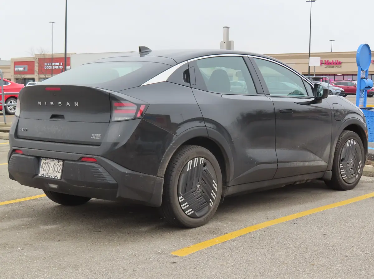 Black 2026 Nissan Leaf S+ rear three-quarter view, a Tesla alternative with 303 miles of EPA range
