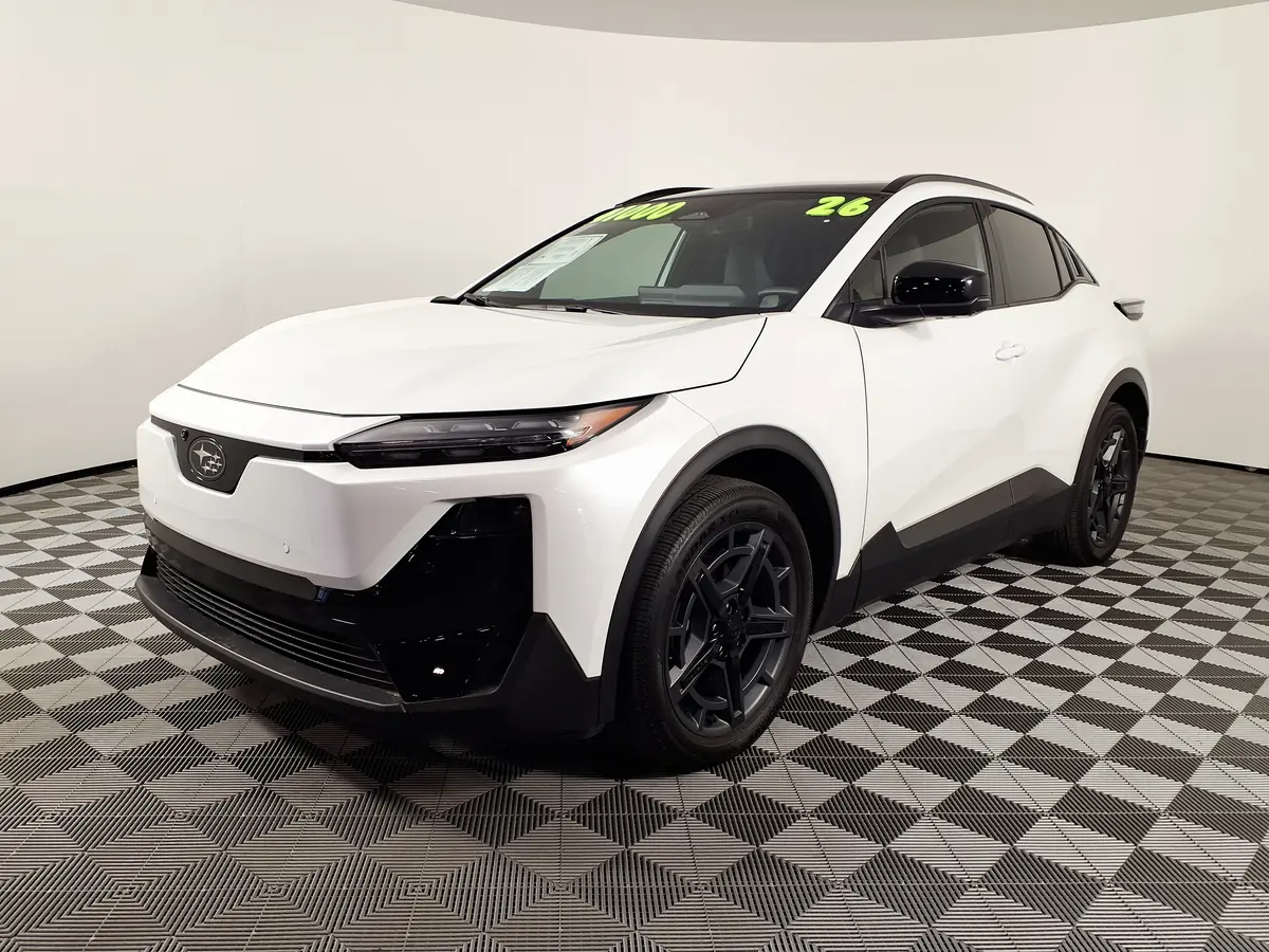 White Subaru Uncharted GT in a dealer showroom, an AWD Tesla alternative with a NACS port