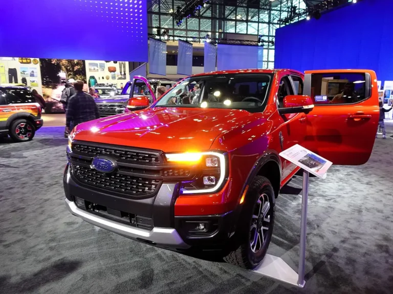 Orange Ford Ranger Lariat SuperCrew on an auto show stand, front three-quarter view, ahead of the 2027 Ford Ranger changes