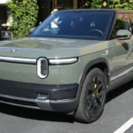 Launch Green Rivian R2 parked outside Rivian's store at Stanford Shopping Center in Palo Alto, California