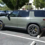 Rivian R2 in Launch Green, side view, the SUV sold with the Rivian R2 Launch Package