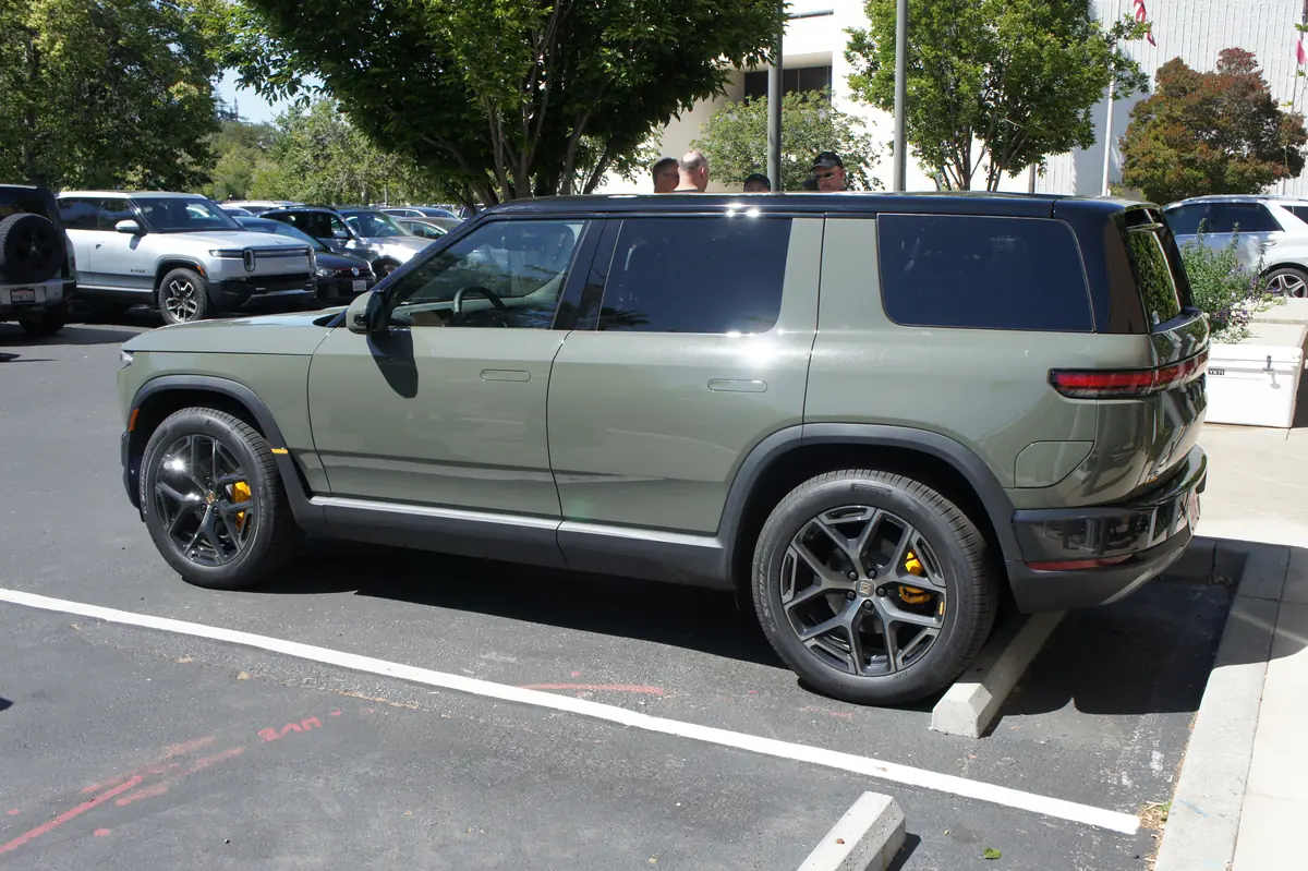 Rivian R2 in Launch Green, side view, the SUV sold with the Rivian R2 Launch Package