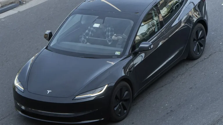 Black Tesla Model 3 Highland on a city street, the sedan at the center of the reported Tesla lease price increase