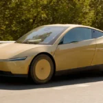 Gold Tesla Cybercab driving on an interstate highway, the robotaxi expected for Tesla Robotaxi San Antonio