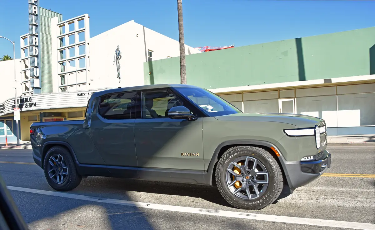 Green Rivian R1T electric pickup truck on Sunset Boulevard in Los Angeles
