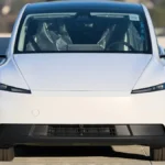 White Tesla Model Y in front view; a smaller Tesla Model 2 compact SUV has been reported but not confirmed