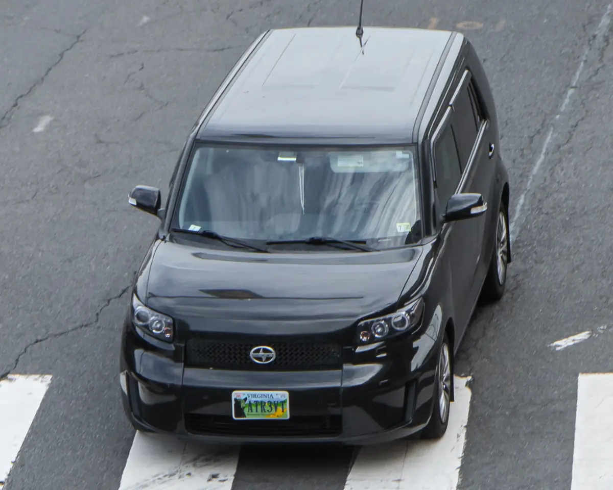 Black second-generation Scion xB boxy compact car seen from above on a city street
